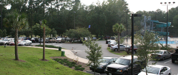 Park parking lot with a few cars in it